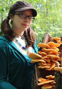 Emily Schmidt with orange & yellow sun fungus (Ryan Bouchard)